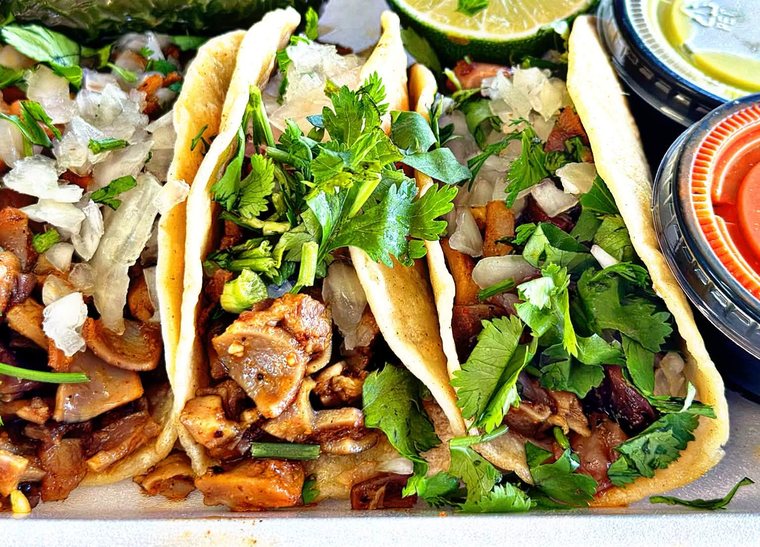 Buche tacos with onion, cilantro and pico de gallo. Photograph posted by Pumbah's Tacos & Burgers.