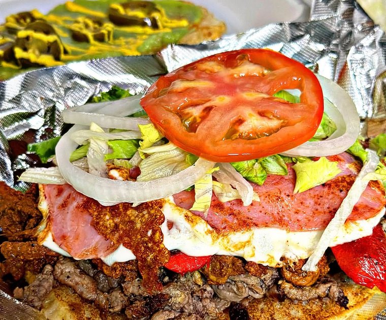 The Pumbah Torta, layered with meat, tomato, onion and avocado. Photograph posted by Pumbah's Tacos & Burgers.